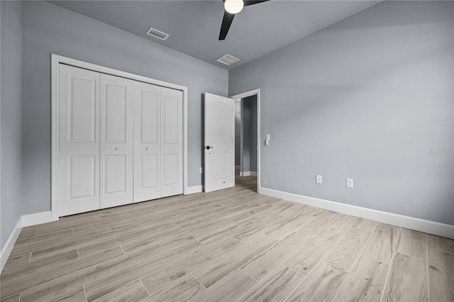 unfurnished bedroom with ceiling fan, a closet, and light hardwood / wood-style floors