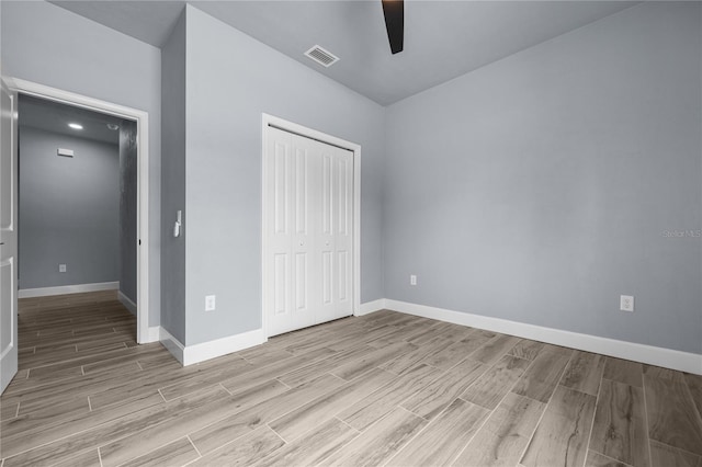 6624 SW 10th Ln, Gainesville, FL 32607 - unfurnished bedroom with light wood-type flooring, a closet, baseboards, and a ceiling fan
