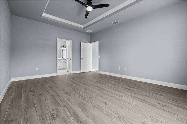 6624 SW 10th Ln, Gainesville, FL 32607 - spare room with a tray ceiling, ceiling fan, wood finished floors, baseboards, and ornamental molding