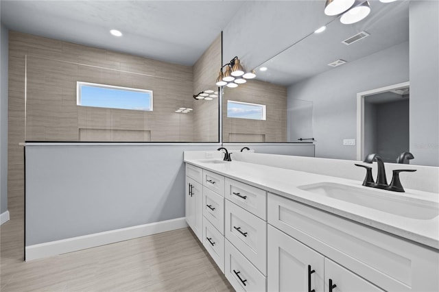 6624 SW 10th Ln, Gainesville, FL 32607 - bathroom with walk in shower, double vanity, wood finished floors, and recessed lighting