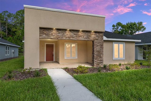 modern home with a lawn and a patio area