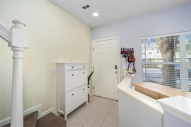 clothes washing area featuring light tile patterned floors, recessed lighting, and visible vents