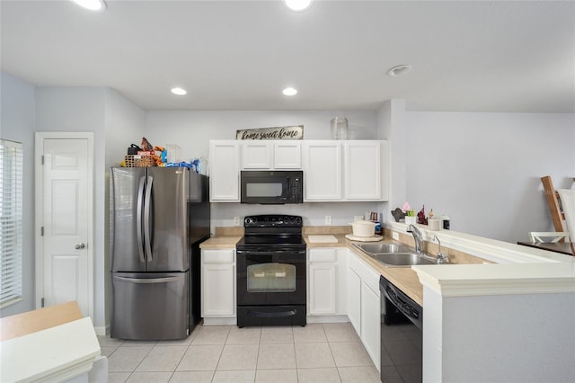 kitchen with a sink, white cabinetry, black appliances, and a peninsula