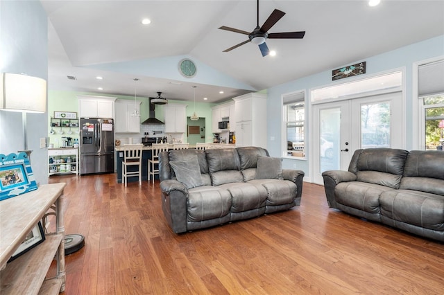 living room featuring ceiling fan, high vaulted ceiling, french doors, and hardwood / wood-style flooring