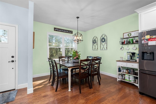 dining room featuring a chandelier and dark hardwood / wood-style flooring