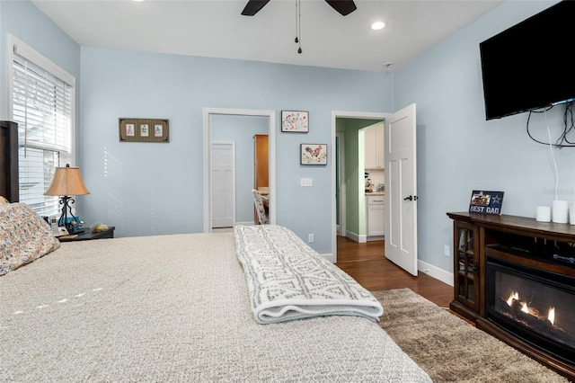 bedroom with ceiling fan and dark hardwood / wood-style flooring