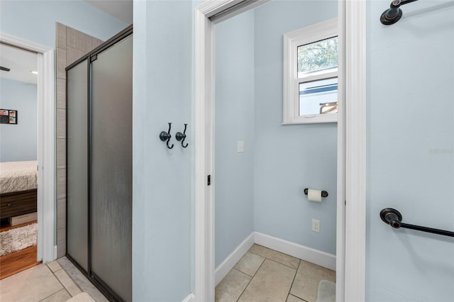 bathroom with walk in shower and tile floors