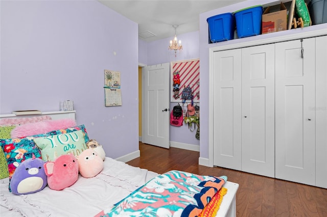 bedroom featuring a closet, a notable chandelier, and dark hardwood / wood-style flooring