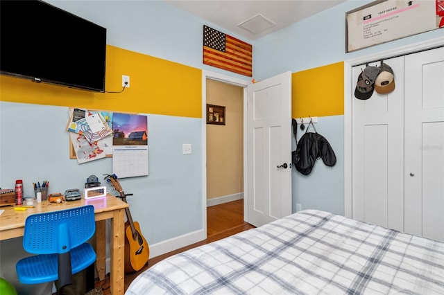 bedroom featuring a closet and dark wood-type flooring