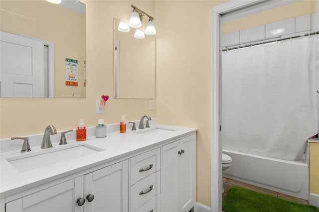 full bathroom with shower / bathtub combination with curtain, toilet, dual sinks, and large vanity