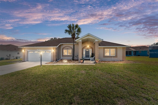 ranch-style house featuring a lawn and a garage