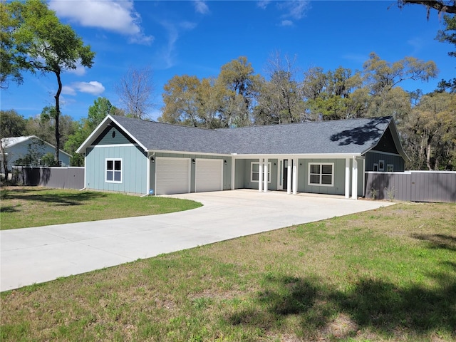 ranch-style house featuring a front yard and a garage