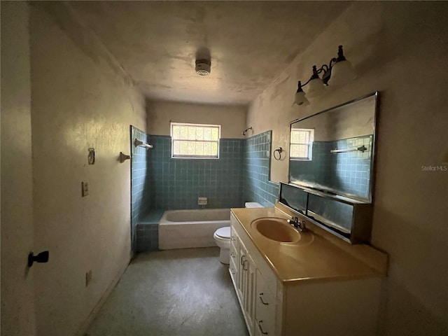 full bathroom with vanity, concrete floors, toilet, and tiled shower / bath