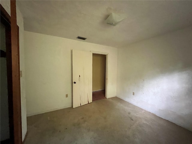 empty room with dark colored carpet