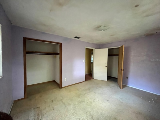 unfurnished bedroom featuring light carpet