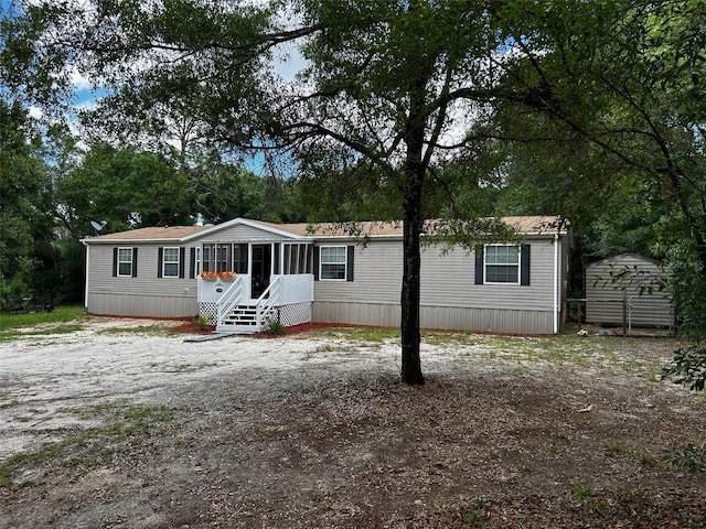 view of front of home featuring a storage shed