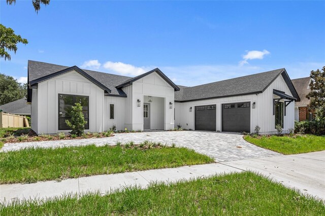 modern farmhouse style home featuring a garage