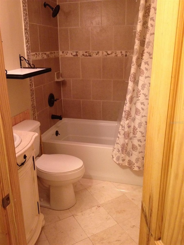 full bathroom with vanity, tile floors, toilet, and shower / bath combo with shower curtain