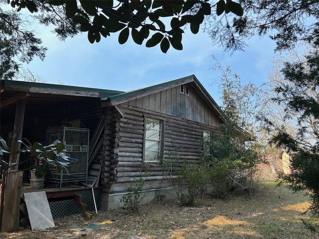 view of side of property featuring a wooden deck