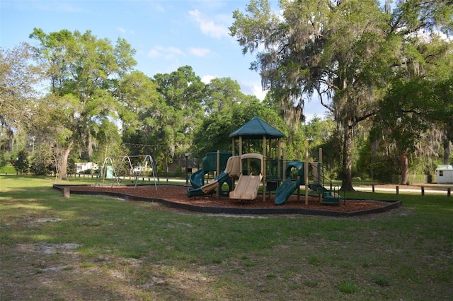 view of playground with a lawn