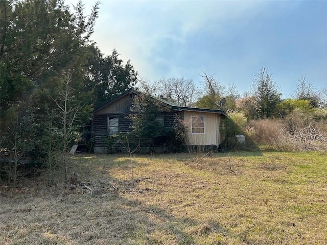 view of property exterior featuring a lawn