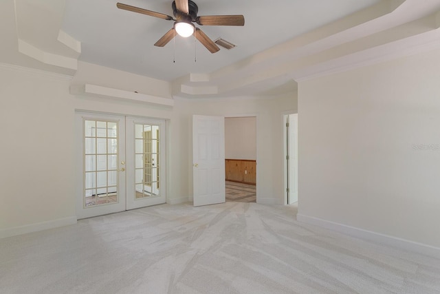 unfurnished bedroom featuring ornamental molding, french doors, a raised ceiling, and ceiling fan