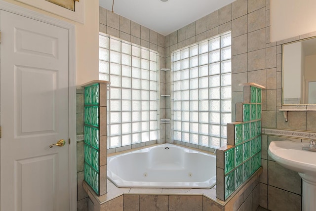 bathroom featuring tile walls and a relaxing tiled tub