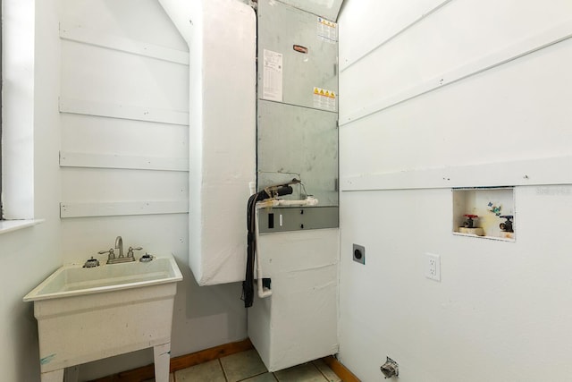 clothes washing area with hookup for a washing machine, light tile patterned floors, and hookup for an electric dryer