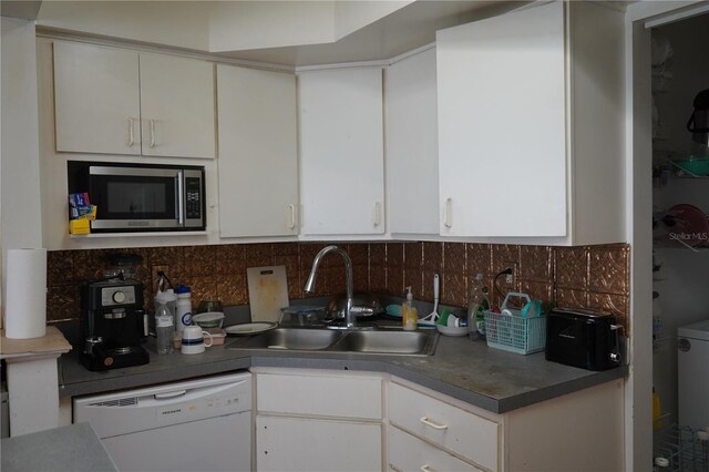 kitchen with stainless steel microwave, white cabinetry, and dishwasher