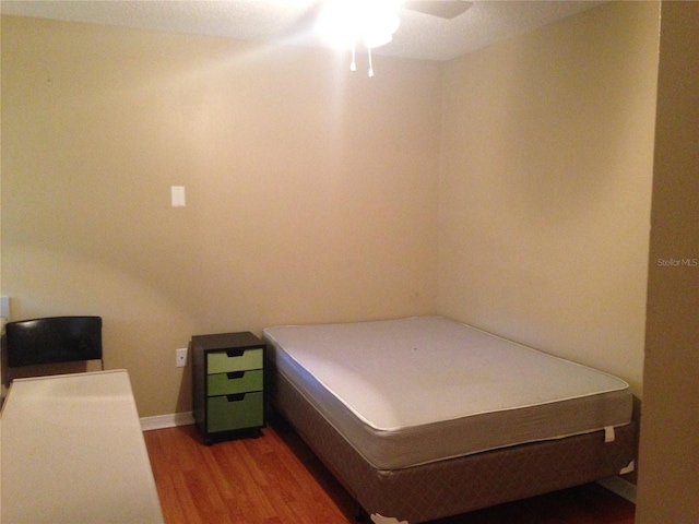 bedroom with wood-type flooring and ceiling fan