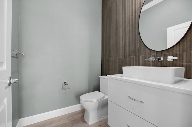 bathroom featuring hardwood / wood-style flooring, vanity, and toilet