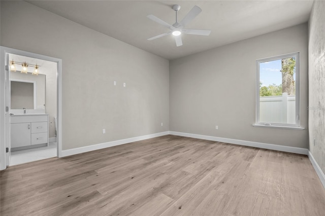 empty room with ceiling fan and light hardwood / wood-style floors