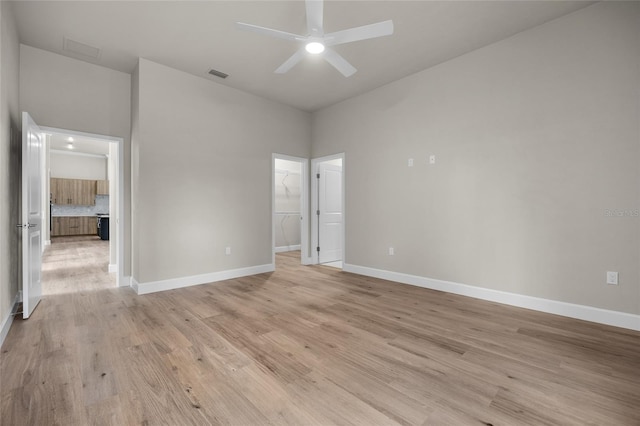 empty room featuring ceiling fan and light hardwood / wood-style floors