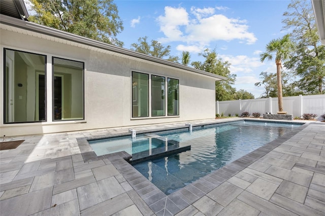 view of swimming pool featuring an in ground hot tub and a patio