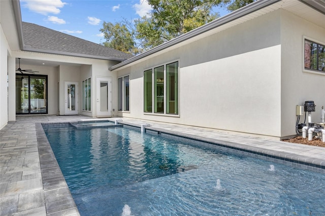 view of swimming pool featuring pool water feature and a patio