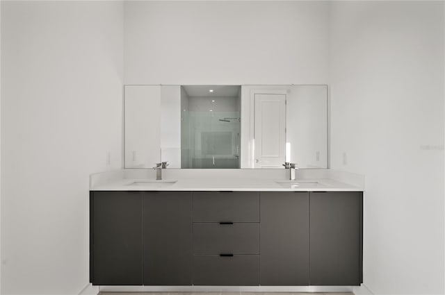 bathroom featuring double sink vanity and a shower