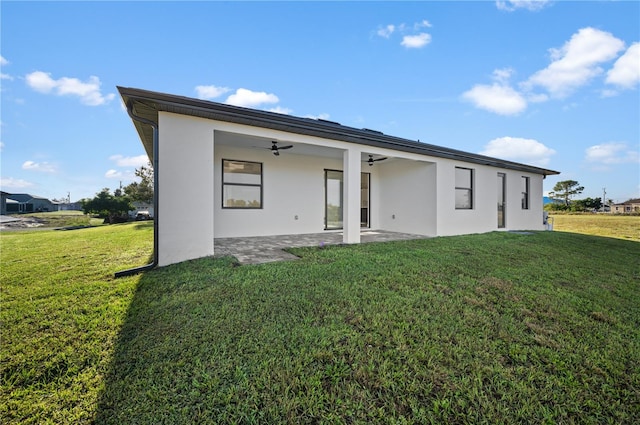 rear view of house featuring a yard, ceiling fan, and a patio