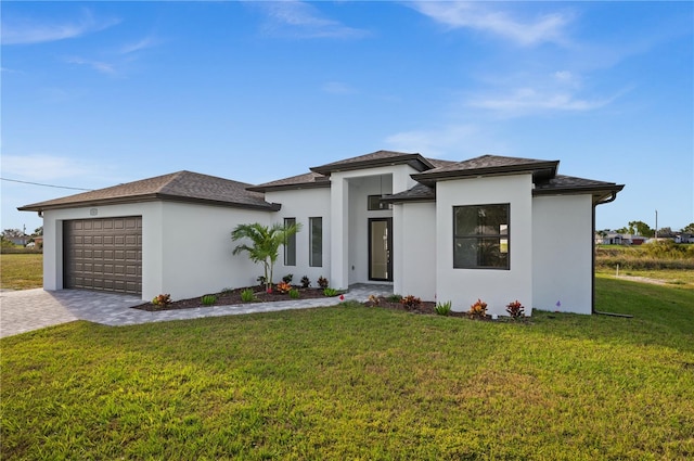 prairie-style home with a garage and a front lawn