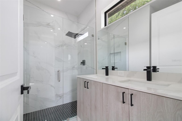 bathroom with vanity and a shower with door