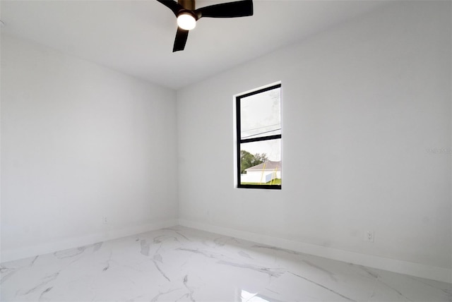 tiled empty room featuring ceiling fan