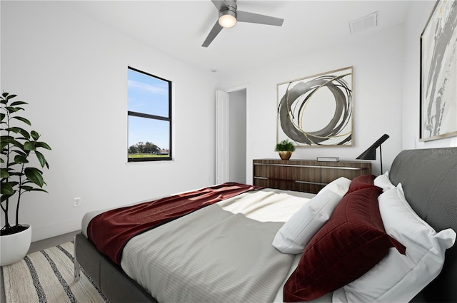 bedroom featuring baseboards, visible vents, and a ceiling fan