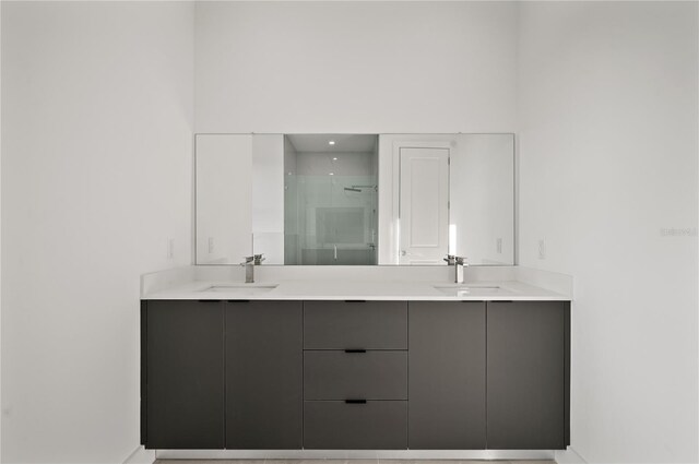 bathroom featuring dual vanity and walk in shower