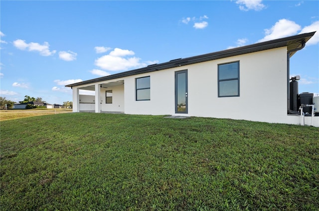 view of front of home with a front yard and stucco siding