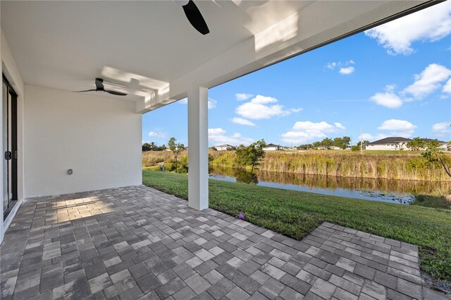 view of patio / terrace with a water view and ceiling fan