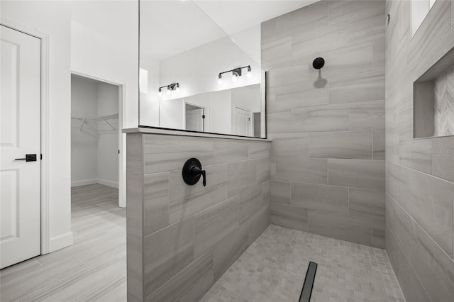 bathroom featuring tiled shower and hardwood / wood-style flooring