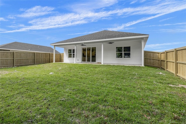 rear view of property with a yard, ceiling fan, and a patio area