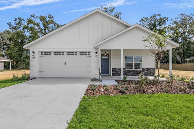 view of front of house with a porch, a garage, and a front yard