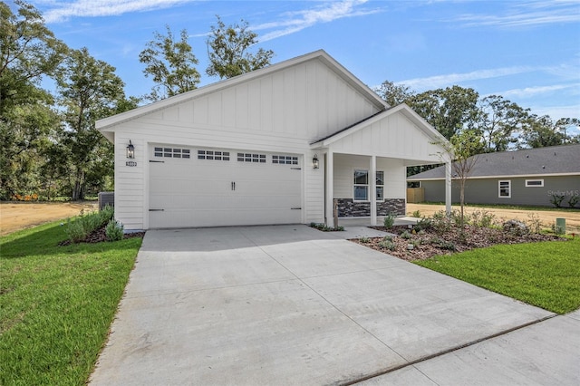 view of front of home with a garage and a front yard