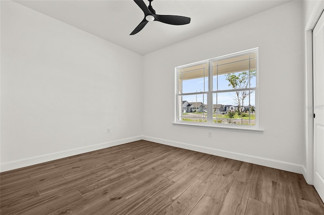 empty room featuring ceiling fan and hardwood / wood-style floors