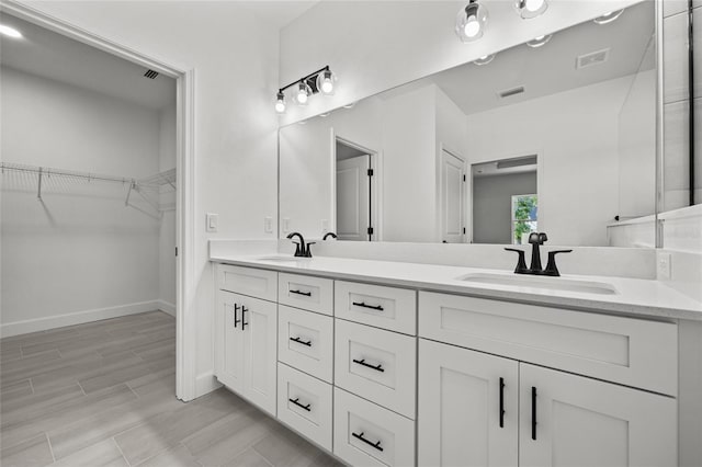 bathroom with vanity and hardwood / wood-style floors